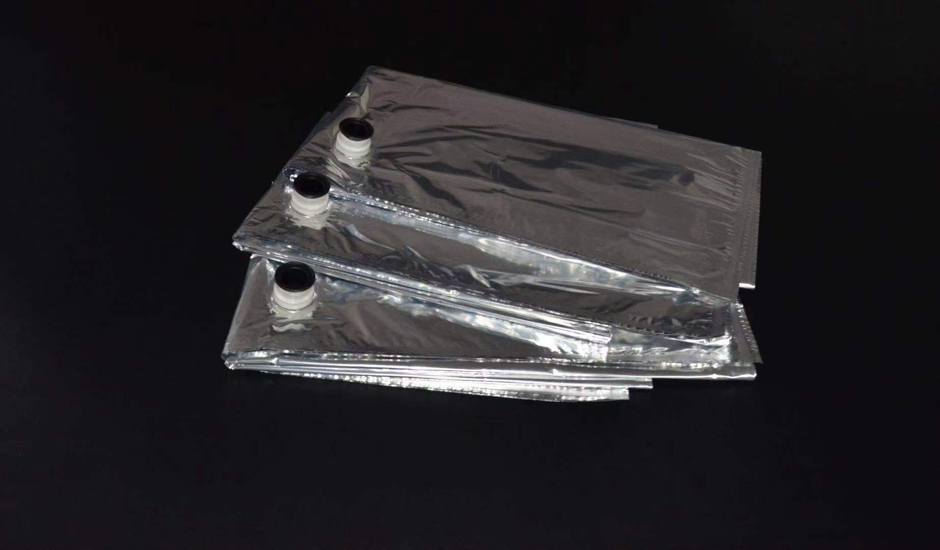 Folded metallized flexible bags with filling spouts