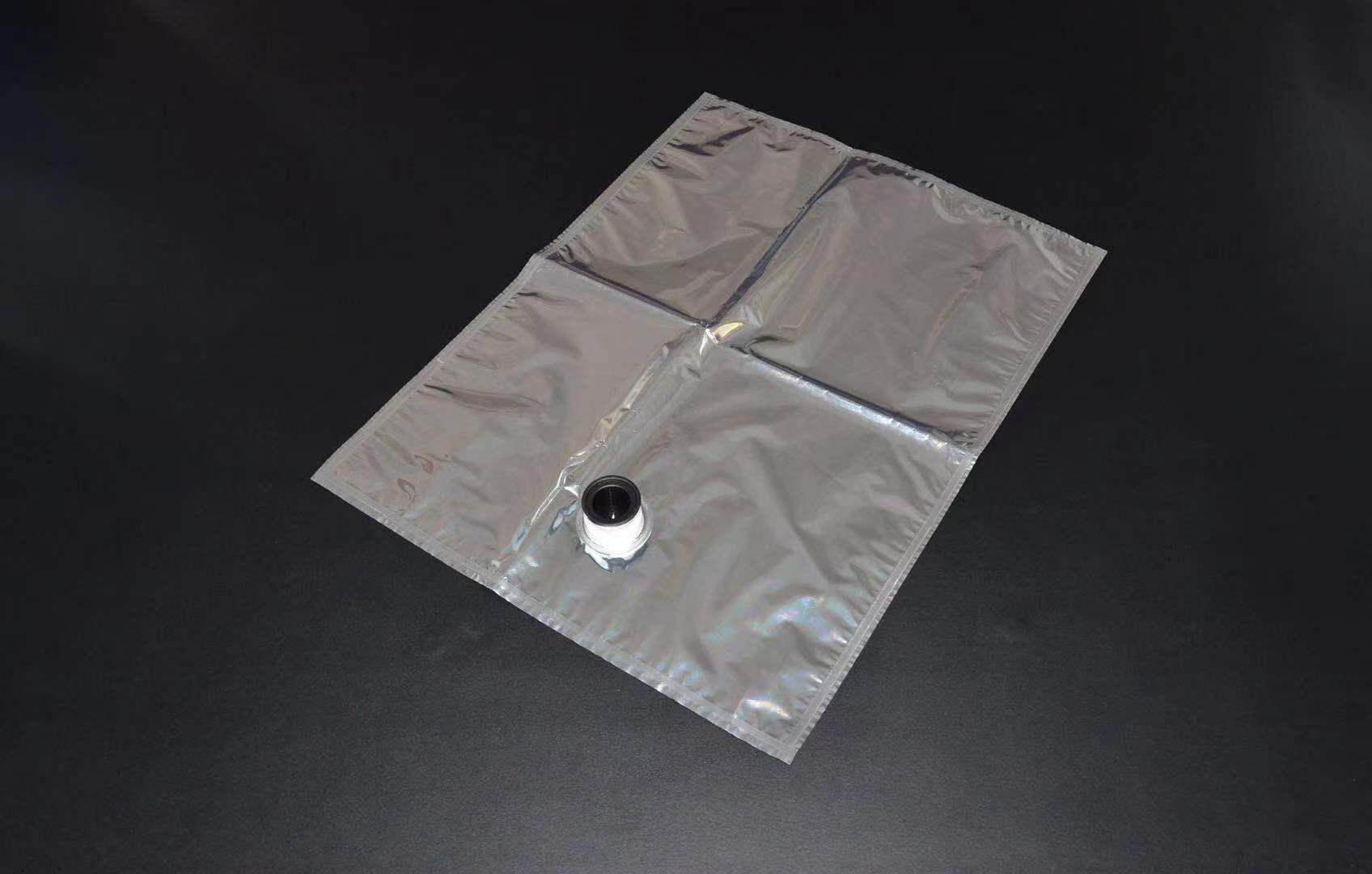 Metallized flexible aseptic bag laid flat with its filling spout visible